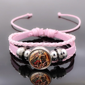 Macro shot of pink layered leather bracelet with Archangel Michael pendant and adjustable cord