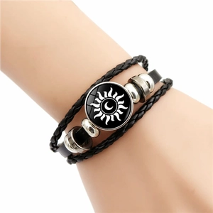 Multilayer leather braided bracelet featuring sun and moon glass charm on wrist