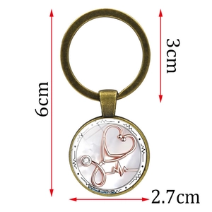Stethoscope and heart glass dome keychain with bronze metal finish and size markings