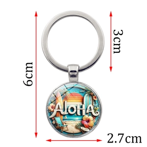 Silver metal Aloha keychain with Hawaii sunset and surfboard patterns in a round glass pendant