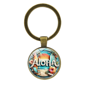 Vintage bronze Aloha keychain with a tropical beach illustration and sunset surf design