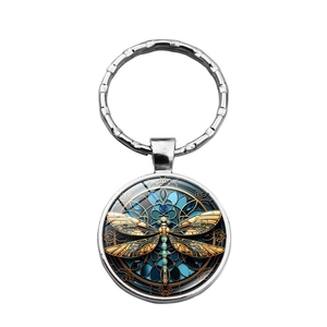 Detailed view of steampunk dragonfly glass gem pendant with metallic silver keyring