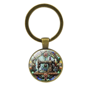 Porte-clés vintage en bronze avec machine à coudre en verre et motifs floraux