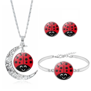 Polka dot ladybug jewelry set featuring crescent moon necklace, earrings and bracelet