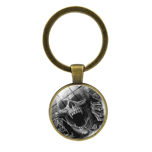 Porte-clés punk gothique en bronze avec motif de squelette sous un dôme en verre