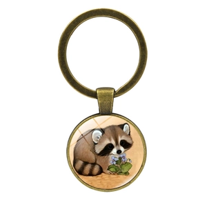 Vintage bronze raccoon keychain with round glass cabochon pendant and purple floral illustration