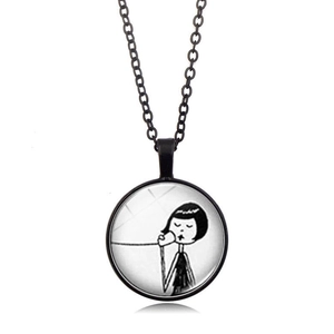 Detail view of black alloy necklace with glass pendant featuring a hand-drawn gothic girl