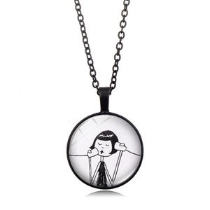 Detail of round Best Friend pendant necklace featuring a black cartoon girl illustration