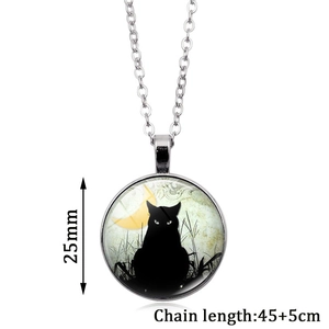 Detail view of 25mm black cat pendant necklace with glowing moon glass dome design