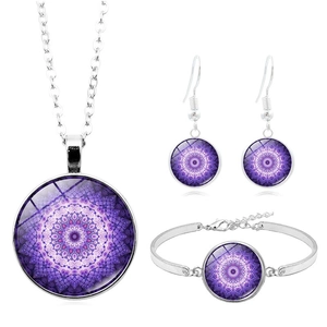 Détail de parure de bijoux argentés avec motifs mandala violets sous cabochon en verre