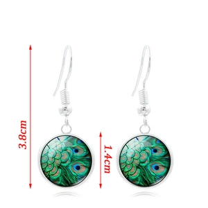 Silver drop earrings with peacock feather pattern and 3.8cm length measurements