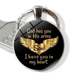 Macro shot of silver memorial keychain with heart and I Have You In My Heart Mom Son text
