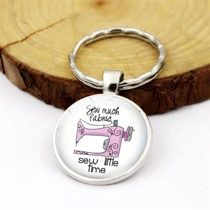 Silver sewing machine keychain with vintage charm and Sew much fabric quote on wood