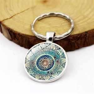 Mandala glass gemstone keychain with a silver metal ring and colorful kaleidoscope pattern