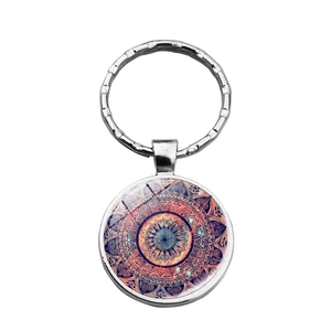 Silver mandala glass cabochon keychain with vibrant geometric orange and blue patterns
