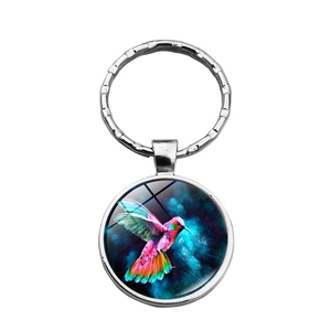 Vibrant hummingbird glass cabochon keychain with silver woven metal ring and star art