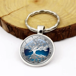 Silver Tree of Life glass gem keychain with white tree design on blue and white background