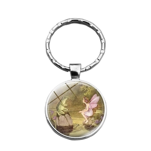 Illustration féerique de fée et prince grenouille sur un porte-clés rond en métal argent