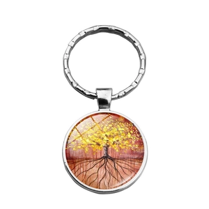 Silver tree of life keychain with golden leaves and red art background glass dome