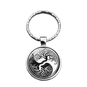 Detail of life tree and yin yang pattern under glass dome for silver keychain