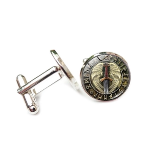 Detailed close-up of silver Viking compass cufflinks with wings and sword emblem