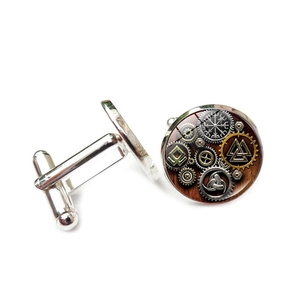 Detail showing the intricate Viking Valknut and steampunk gear pattern on silver cufflinks