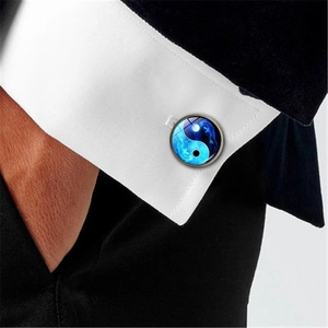 Polished silver cufflink with blue Yin Yang dragon art glass on white French shirt