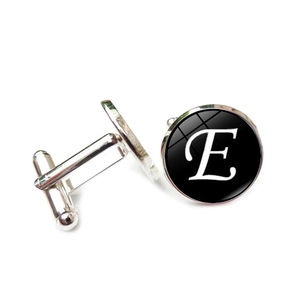 Macro shot of silver letter E cufflinks with black background and T-shape back closure