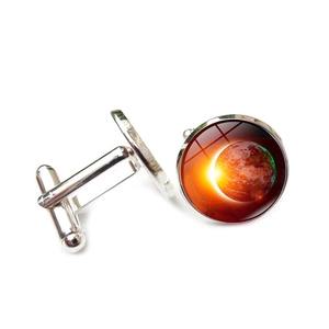 Polished silver cufflinks with a round glass dome featuring a scenic Earth and sunrise design