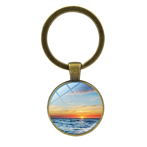 Porte-clés vintage en bronze avec coucher de soleil sur la plage et pendentif rond en métal