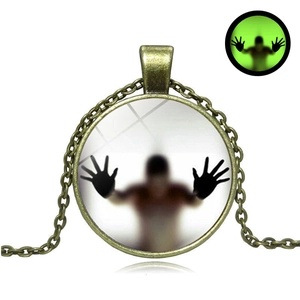 Vintage bronze Halloween luminous necklace with glowing green pendant on white background