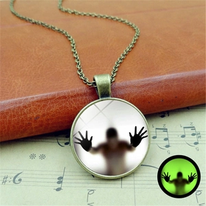 Vintage bronze luminous Halloween necklace with spooky silhouette pendant on music sheet
