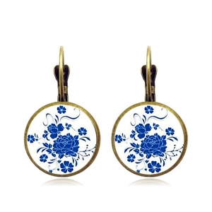 Detail of blue and white floral pattern glass earrings with bronze leverback closure