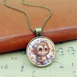 Vintage bronze pendant necklace featuring a cute cartoon monkey and floral glass cabochon