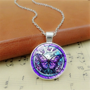 Vintage purple butterfly glass gem necklace with silver chain on retro music sheet