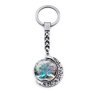 Rotating Tree of Life moon pendant keychain made of polished silver metal on white background