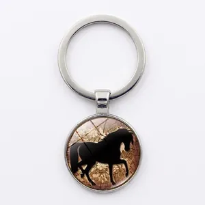 Close-up of a silver horse silhouette keychain with vintage glass pattern and round alloy frame