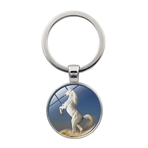 Close-up of a silver horse head pendant keychain with blue sky art under glass dome