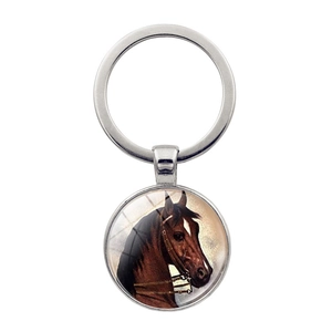 Silver horse head keychain with round glass cabochon pendant on white background