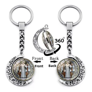Rotating St. Benedict moon keychain showing front and back views on silver metal