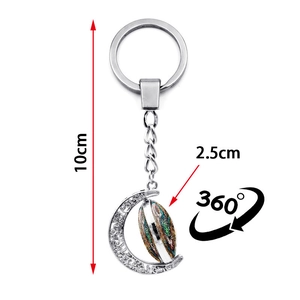 Rotating crescent moon owl glass pendant keychain in silver finish with 360-degree spin