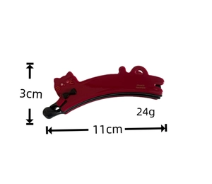 Detail view of burgundy cat-shaped banana hair clip with bow and dimension markings
