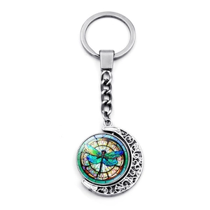 Vintage silver moon keychain featuring a colorful dragonfly glass gem pendant on white background