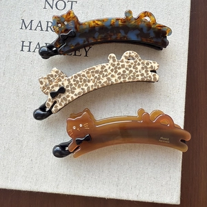 Three cute cat-shaped acetate banana hair clips in tortoiseshell and amber patterns