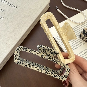 Rectangle acetate hair claw clips in marble and dalmation patterns for women's hair styling