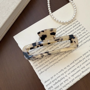 Detail of large hollow rectangular claw clip with vintage tortoiseshell texture