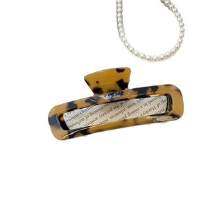 Elegant rectangle cutout hair claw clip in tortoiseshell acetate with minimalist design