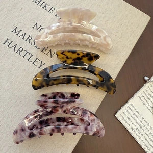 Three-piece acetate claw clip set in marble, tortoiseshell, and grey patterns