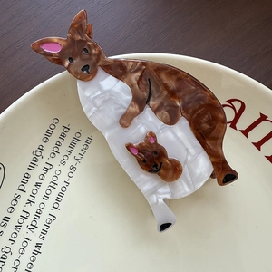 Detail of kangaroo shaped acetate hair claw clip with brown tortoiseshell texture on plate