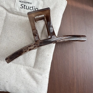 Macro detail of large tortoiseshell resin hair claw clip with strong metal spring mechanism
